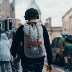man walking down the street with headphones