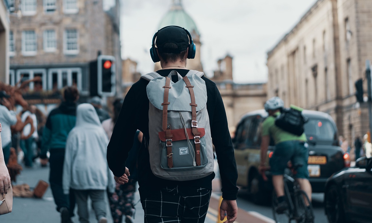 man walking down the street with headphones