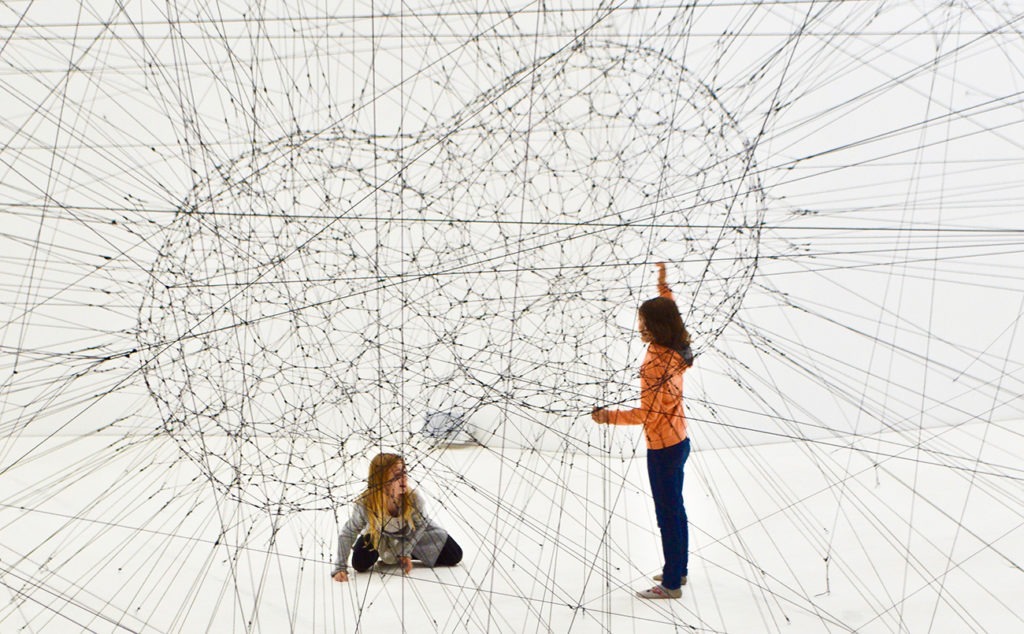 two little girls playing with an art installation symbolising 'networking'