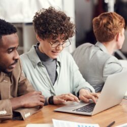 mand and women looking at a computer together