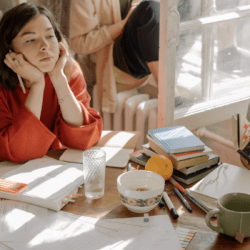 a woman at a table of people looking bored