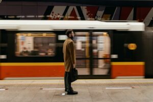 a man waiting for a train with a briefcase