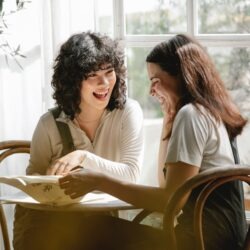 two women enjoying working together in conversation