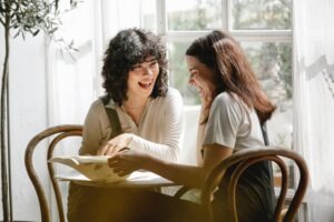 two women enjoying working together in conversation