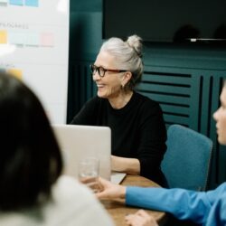 woman smiling with her coworkers