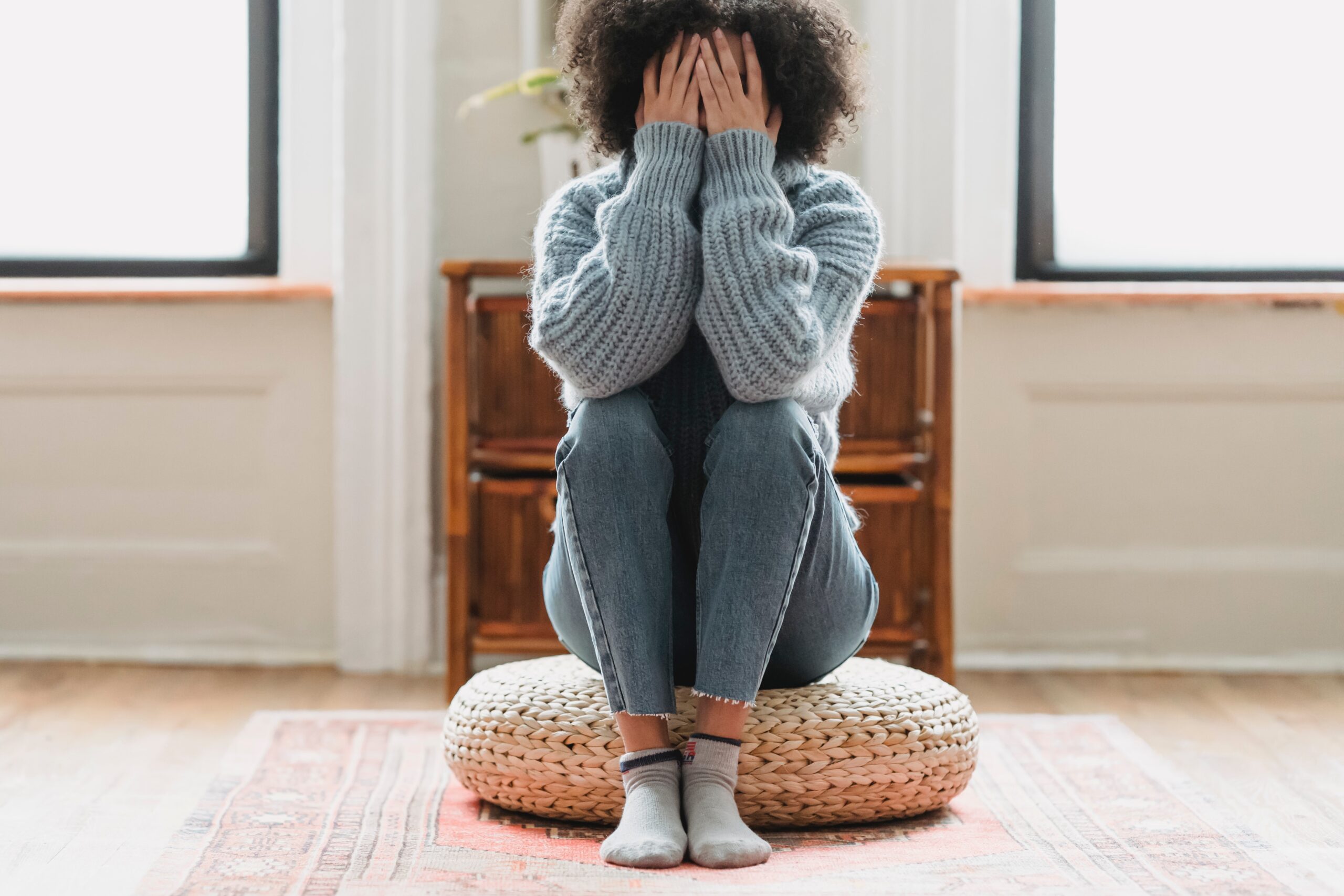 a woman sitting with her head in her hands