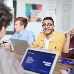 Man at work with colleagues
